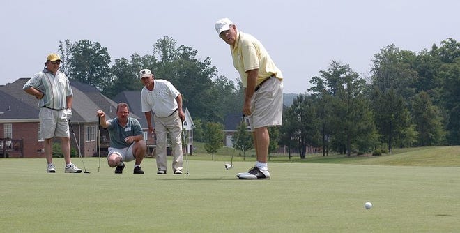 Agolf tournament was held at Woodfin Ridge recently to support the American Cancer Society's Relay for Life. Watching Bob Brown's putt are, from left: Pete Inman, Steve Wilson and Randy Hartsell.