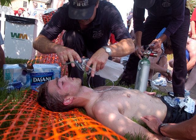 Portsmouth firefighters treat Jeremy Lampert, of Portsmouth, after he ran the Market Square Day 10k on Saturday. The weather drew large crowds to beaches in New Hampshire and southern Maine, though Market Square Day siphoned off some of the crowds.

Aaron Rohde/
Staff photographer