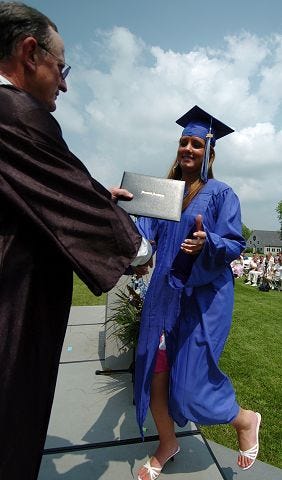 Kelley Coughlan receives her diploma from Board of Trustees President Charles Clement III during Berwick Academyís 214th Commencement Ceremony for the Class of 2005 Saturday.