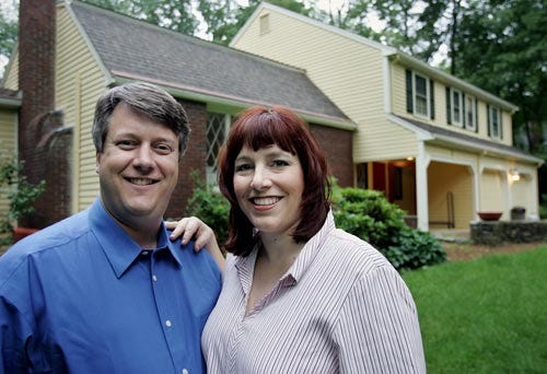 Dennis O'Connor, left, and his wife Erika stand in front of their home in Wayland, Mass., on Tuesday. Marriage can be more challenging the second time around and it's often money that creates the most difficulties.