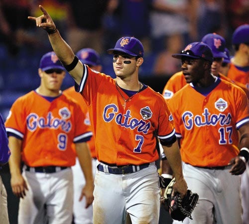 Florida's Jeff Corsaletti points towards the small group of Gator fans above the dugout after the Gators' 7-4 win against Nebraska on Sunday the College World Series at Rosenblatt in Omaha, Neb.