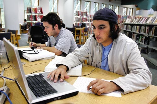 Carlos Rivero uses the Internet connection with his laptop at the Alachua County Headquarters Library in downtown Gainesville as he studies for his Dental Admissions Test. The library has ports for use with laptops and will be providing a wireless Internet connection in the near future.