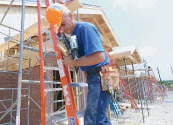 Jim Catsinas of Nebraska scales a ladder at the new Hope Chapel.Steve King photo