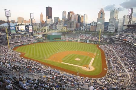 With the city skyline looming large over the outfield, Fans take in a game at PNC Park in Pittsburgh, Pa. Knight Ridder Tribune photo