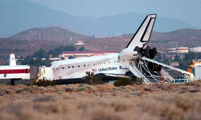 The Space Shuttle Discovery is attended to on runway 22 after landing Tuesday,Tuesday, Aug. 9, 2005, at Edwards Air Force Base Calif. (AP Photo/Antelope Valley Press, Ron Siddle)