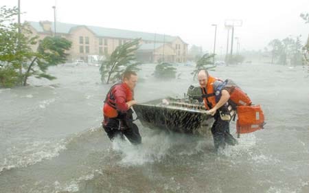 Fire and rescue personnel launch a boat amid floodwaters from Hurricane Katrina, as they head out to rescue a family Monday outside a hotel in Pascagoula, Miss. AP photo