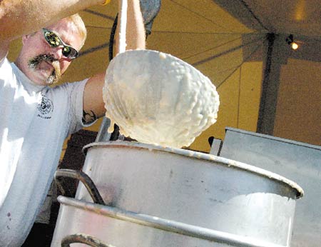 Hampton firefighter Bill Paine ladles out a large helping of clam chowder at this weekend?s Seafood Festival.
