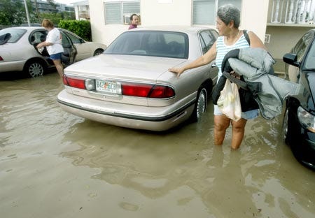 Anarminda Leyva carries an armload of clothing from her flooded apartment in Key West, Fla., Wednesday after Hurricane Rita left waters in some places a foot deep.
AP photo