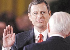Supreme Court Justice John Paul Stevens swears in John Roberts as chief justice of the United States in the East Room of the White House Thursday in Washington.
AP photo