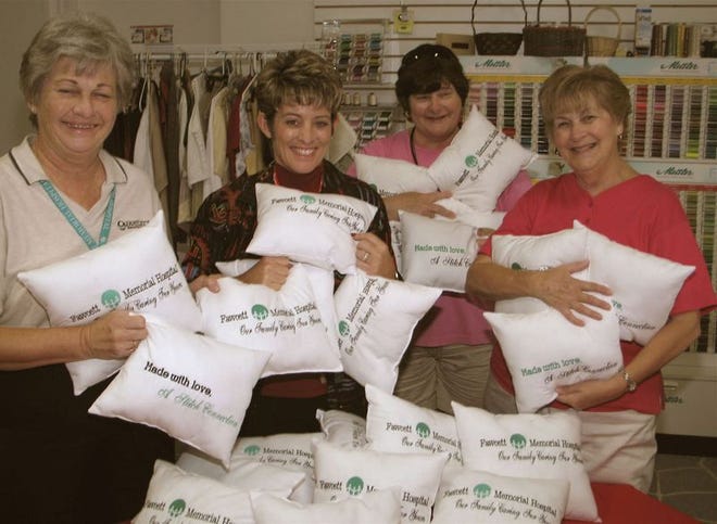 Janet Walker, Carol Vealey-Ellis, Karen O'Connell and Dolores Travers hug the new huggable pillows they made for Fawcett Memorial Hospital patients.