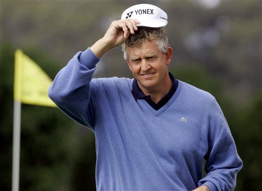 Colin Montgomerie of Scotland tips his hat to the crowd after finishing on the 18th hole during the second round of the American Express World Golf Championships at Harding Park in San Francisco, Friday, Oct. 7, 2005.
