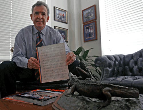 John James, executive director for the Gator Boosters, holds a copy of the score for "We Are the Boys From Old Florida." "We Are The Boys" is very similar to songs sung at the University of Florida and in the Toledo public school system.