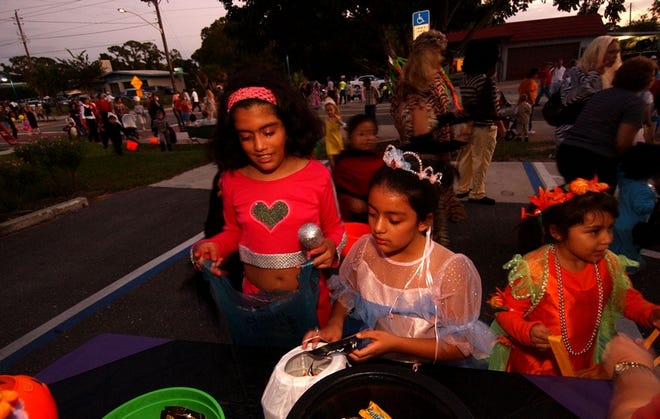 From left, Kelly Guido, 10, Jessica Guido, 7, and Diane Guido, 5, trick-or- treat along Englewood's West Dearborn Street during last year's Halloween Safe Walk.
 HERALD-TRIBUNE ARCHIVE