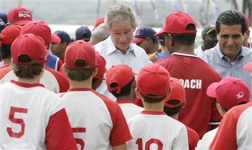 President Bush meets with Panamanian little leaguers at Ciudad del Saber in Panama City on Monday. Panama's President Martin Torrijos is at right.