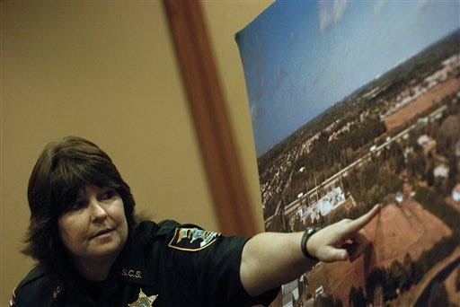 Sarasota County Sheriff's deputy Sheila Sullivan points out where she found the body of Carlie Brucia - at the central Church of Christ - during the third day of joseph Smith's first-degree murder trial Wednesday.
