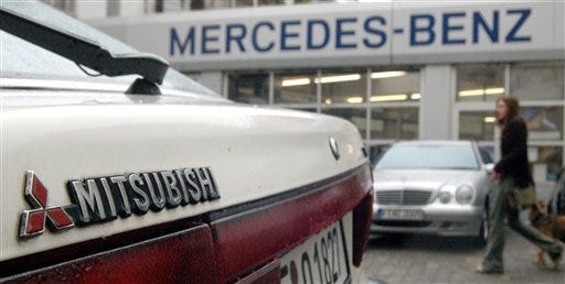 A Mitsubishi car sits outside a DaimlerChrysler dealership in Frankfurt, Germany.