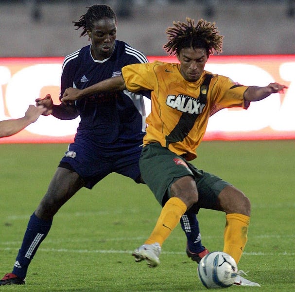 The Los Angeles Galaxy’s Guillermo Ramirez, right, battles the New England Revolution’s Shalrie Joseph during overtime.