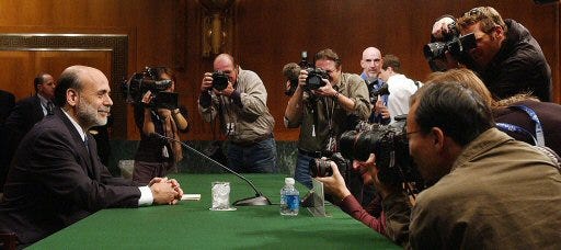 Photographers surround top White House economic adviser Ben Bernanke, who is nominated to become Federal Reserve chief, prior to his testimony before the Senate Banking Committee on Tuesday.