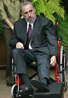 Cuban President Fidel Castro sits in wheelchair while recovering from a fall he took while giving a speech in 2004.