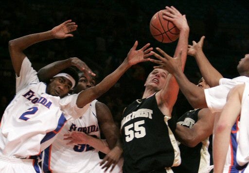 Florida's Corey Brewer (2) and Chris Richard battle Wake Forest's Kyle Visser for a rebound during the Gators' 77-72 victory on Thursday.