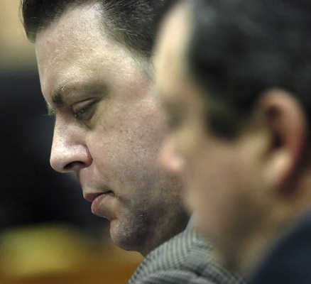Joseph Smith, left, looks down yesterday as the jury receives instructions before beginning deliberations in his trial.
