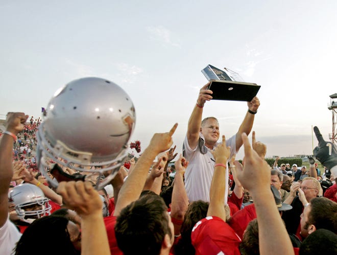 Nicholls State coach Jay Thomas raises the Southland Conference championship trophy after the Colonels beat McNeese State 39-26 Saturday in Thibodaux. It’s the program’s first SLC football title.
