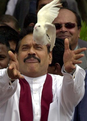 Mahinda Rajapakse frees a pigeon after being sworn in as Sri Lanka's new president in Colombo on Saturday.
