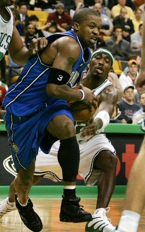 Boston Celtics Ricky Davis (12) tries to grab the ball from behind as Orlando Magic's Steve Francis (3) drives to the hoop during the fourth quarter of their NBA game in Boston Monday.