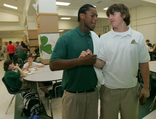 Dion LeCorn, left, and Justin Klobfenstein, starters on Trinity Catholic's football team, meet in the cafeteria Monday.