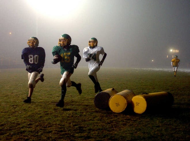 Players run through a series of warm-up drills in the fog at Fuller Field last night, preparing for their hoped-for trip to Arizona.