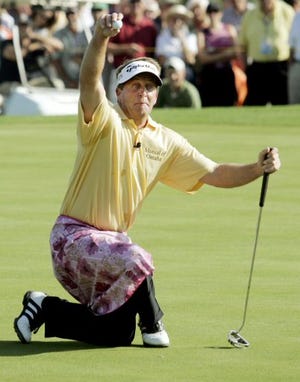 Fred Funk kneels awkwardly in a floral pink skirt given to him by Annika Sorenstam after she outdrove him, on the third hole on the first day of the Skins Game.