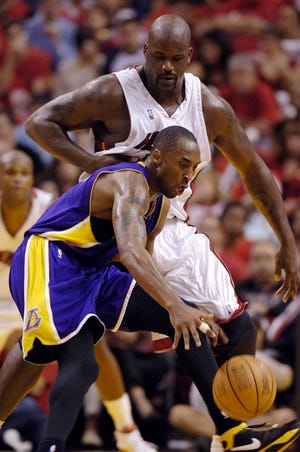 Pressure
 The Lakers' Kobe Bryant scrambles for a loose ball as the Heat's Shaquille O'Neal applies pressure during the third quarter Sunday. The Heat won 97-92.