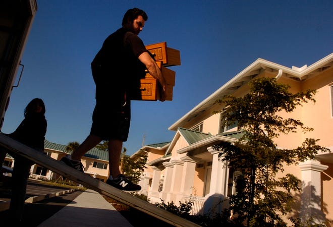 Jimmy Cirillo moves his furniture into his Rosemary Park condominium Friday in Sarasota. He's happy with his new home.