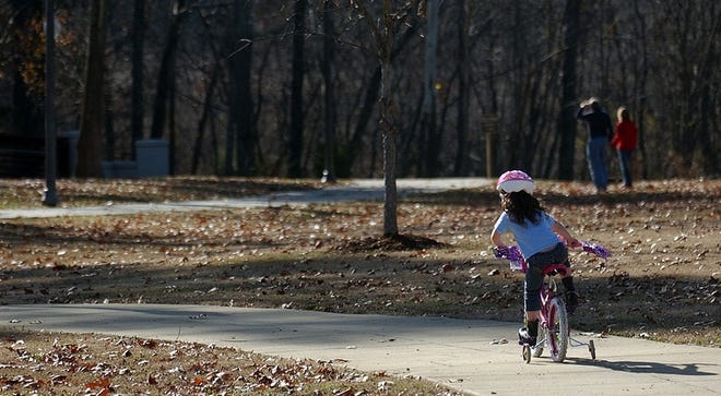 Kristina Stone, 5, rides her new bike from Santa Claus on the Riverwalk at the River Road Park. “She was tickled to death," Kristina’s father, Robert Stone, said of her receiving the new bike for Christmas. “I bet she’s ridden 50 miles on it." The Stones were among several people outside enjoying the unusually warm December temperatures Tuesday. Phase IV of the Riverwalk is being dedicated today.