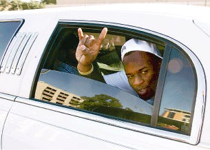 Vince Young flashes the "Hook 'em Horns" sign before leaving Austin in a limousine Sunday.