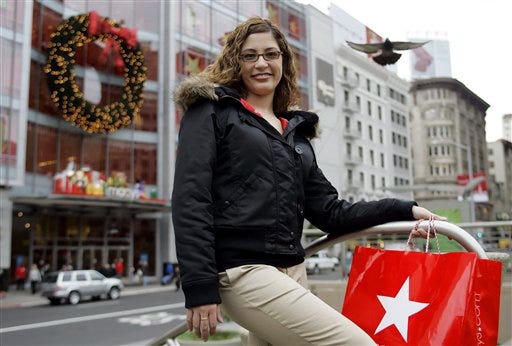Erica Jostedt of San Francisco poses for a portrait at Union Square in San Francisco, Tuesday Dec. 13, 2005. In the background is the Macy's store at left. Jostedt loves to shop, but she hates paying with cash or a check.