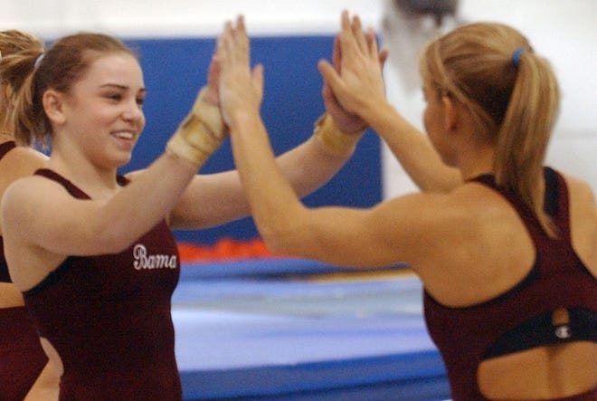 Alabama gymnast Brittany Magee, left, is congratulated by teammate Ashley Ford after a vault routine during practice at Coleman Coliseum on Wednesday.
