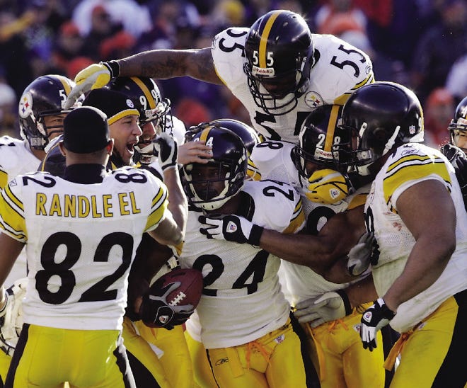 Pittsburgh Steelers cornerback Ike Taylor (24) is congratulated by teammates after he intercepted a pass from Denver Broncos quarterback Jake Plummer during the second quarter of their AFC Championship game in Denver on Sunday. Pittsburgh's Antwaan Randle El (82) and Joey Porter lead the celebration.