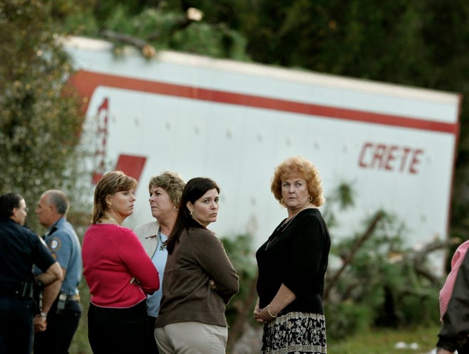 Union County School officials gathered at the accident scene involving a school bus, car and semi truck on State Road 121 near Lake Butler. Left to right are Marcie Tucker, Lynn Bishop, Lake Butler Elementary School principal, Union County High School school nurse, Kim Libby and Principal Gail Lappalainen.