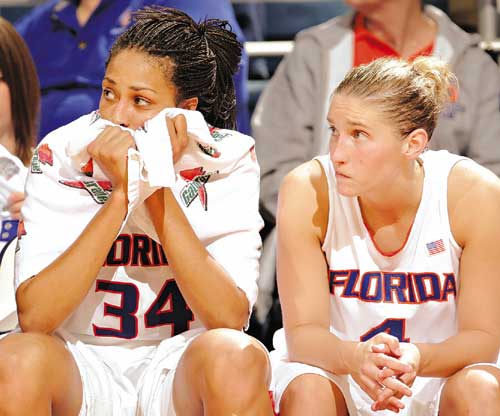 Florida's Dalila Eshe, left, and Kim Dye watch from the bench.