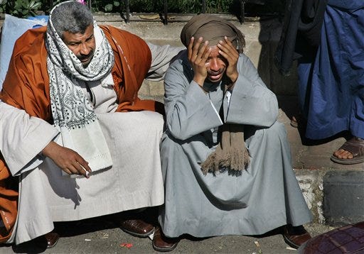 A distraught relative, right, is comforted outside the port in Safaga, Egypt, on Sunday as friends and relatives continue to wait for news of loved ones after Friday's ferry disaster.
