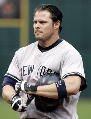 ** FILE ** New York Yankees' Jason Giambi takes off his gloves after poping out to left in the second inning against the Cleveland Indians Thursday, Aug. 4, 2005 in Cleveland. Nearly a year to the day after he fidgeted through a news conference in which he all-but-admitted using steroids, the New York Yankees first baseman was celebrated for his charity TUesday, Feb. 7, 2006 in New York. (AP Photo/Tony Dejak)
