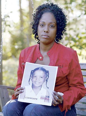 Miranda Jones holds a photograph recently in Bartow that has been altered to show what her missing daughter, Ta'niyah Leonard, might look like today.