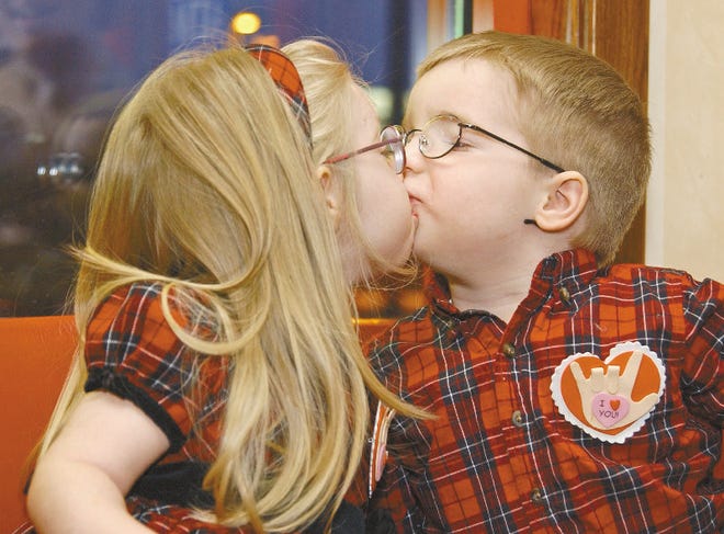 Grace and Gabriel Snyder, twins from Pen Argyl, express their love for each other in spite of their lack of communication abilities. The 2-year-olds are the 2006 Easter Seals child ambassadors.