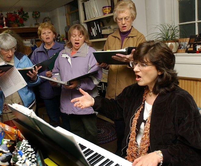 Choir director Kathy Knox (right) leads choir practice at Mt. Olivet United Methodist Church Wednesday evening.