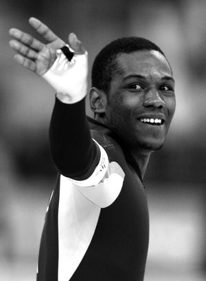 Shani Davis of the United States smiles after competing against Jeremy Wotherspoon of Canada (not seen) during the men's 1000 meter speedskating race at Oval Lingotto during the 2006 Winter Olympics in Turin, Italy, Saturday, Feb. 18, 2006. Davis won the gold medal.