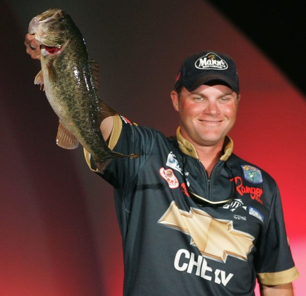 Professional angler Luke Clausen holds up one of his winning catches at the CITGO Bassmaster Classic on Sunday.