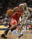 Tracy McGrady, from Auburndale, of the Houston Rockets, drives Sunday against Grant Hill of the Magic in the second half at Orlando. Houston won, 89-84.