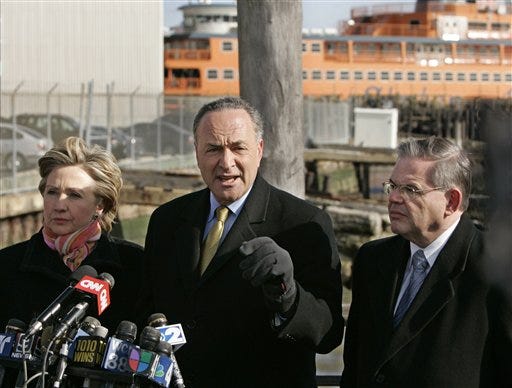 With the Staten Island ferry behind them, Sen. Hillary Clinton, D-N.Y., left, and Sen. Robert Menendez, D-N.J., right, flank U.S. Sen. Charles Schumer, D-N.Y., as he speaks to the reporters in Battery Park, Sunday in New York. Dubai-owned DP World, a United Arab Emirates company, on Sunday offered to submit to a broader U.S. review of the security risks from its deal to take over major operations at six American ports.