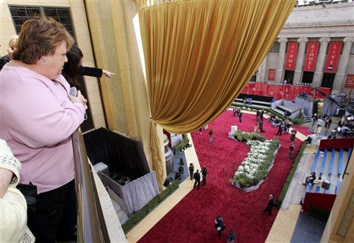 Fans take a look at the red carpet above a rehearsal for the ABC Oscar pre-show outside the Kodak Theatre in Los Angeles, Saturday as preparations are underway for Sunday's 78th Academy Awards